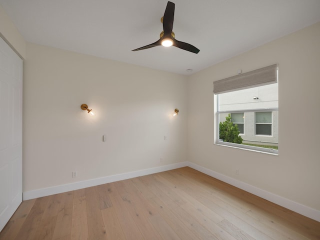 empty room featuring ceiling fan and light hardwood / wood-style flooring