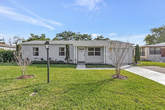 ranch-style home with a front lawn