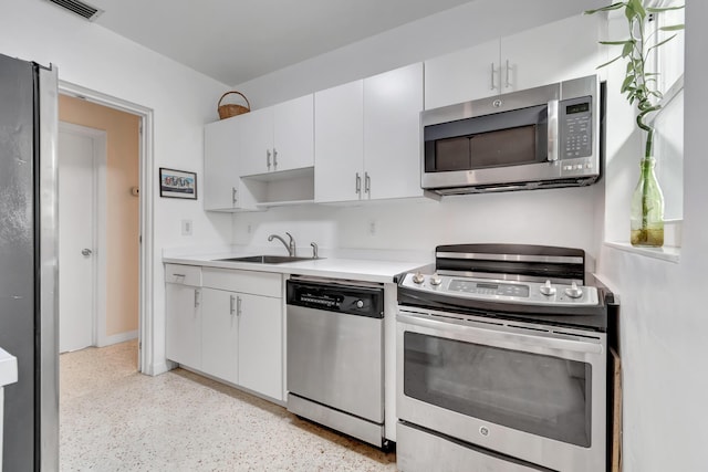 kitchen with white cabinets, sink, and appliances with stainless steel finishes