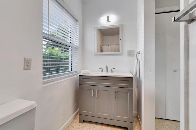 bathroom featuring vanity and toilet