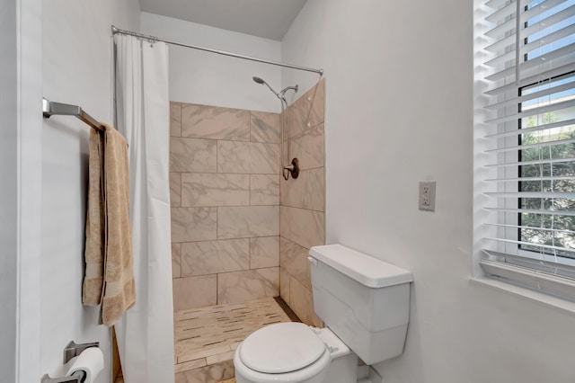 bathroom featuring toilet and walk in shower