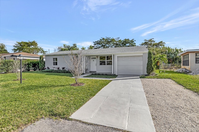 ranch-style house featuring a garage and a front lawn