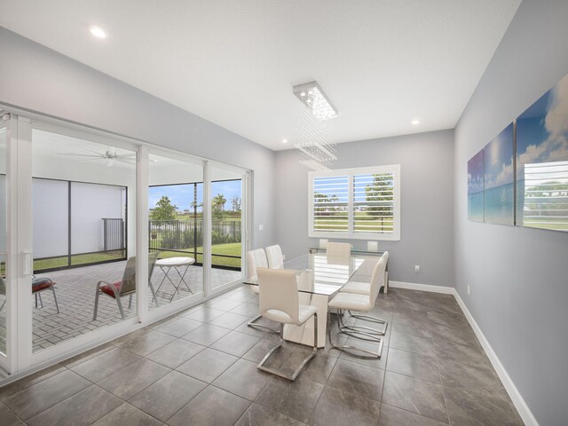 dining area featuring ceiling fan with notable chandelier