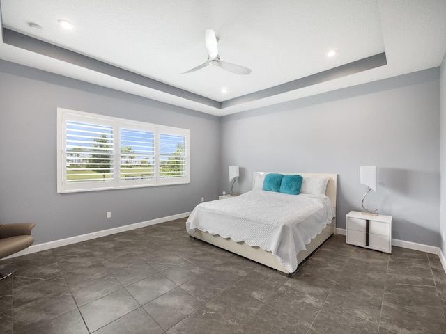 bedroom featuring a tray ceiling and ceiling fan