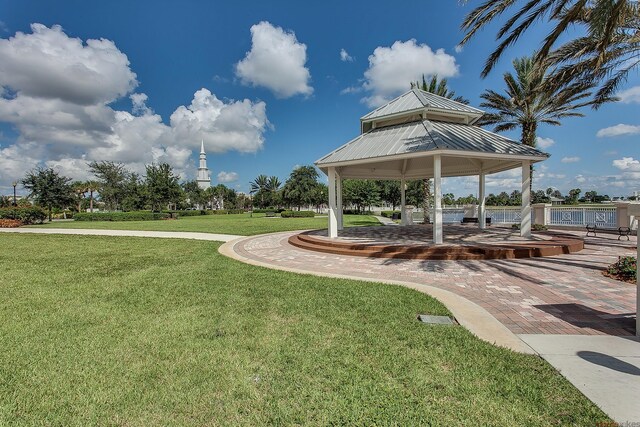 view of property's community with a lawn and a gazebo