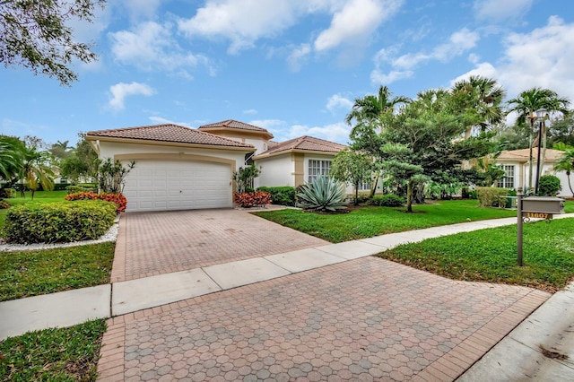 mediterranean / spanish house featuring a front lawn and a garage