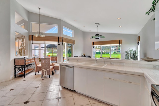 kitchen featuring dishwasher, white cabinets, a healthy amount of sunlight, and sink