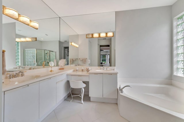 bathroom featuring tile patterned flooring, vanity, and separate shower and tub