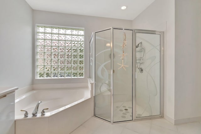 bathroom featuring tile patterned flooring and shower with separate bathtub