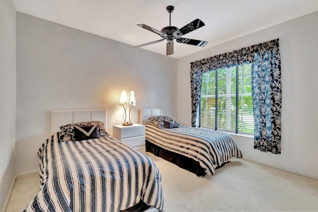 bedroom with ceiling fan, carpet floors, and multiple windows