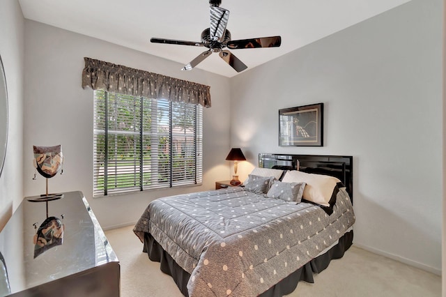 bedroom with ceiling fan and light carpet