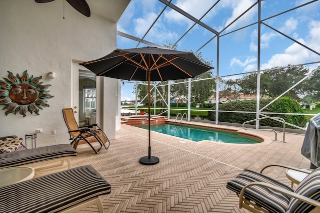 view of swimming pool with a patio area, ceiling fan, and a lanai