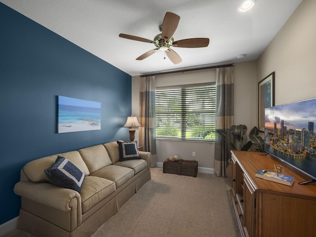 carpeted living room with ceiling fan