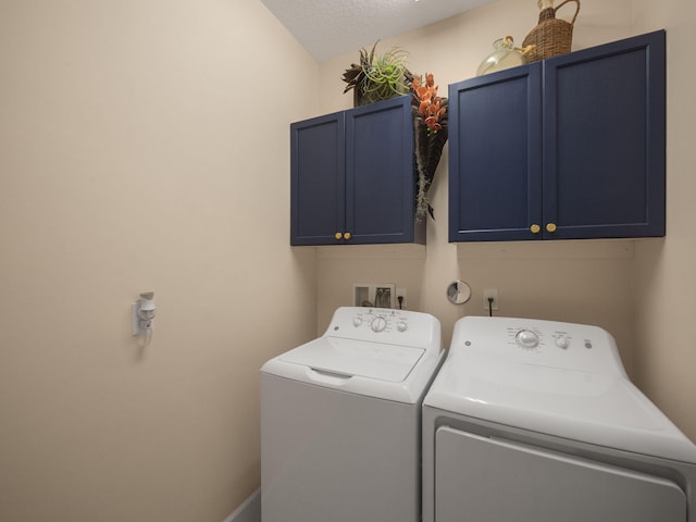 laundry room with washer and clothes dryer, cabinets, and a textured ceiling