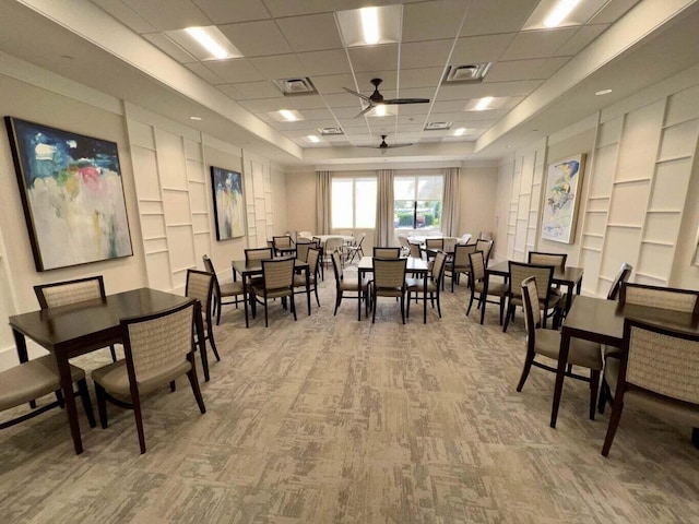 dining space featuring carpet flooring, a paneled ceiling, and ceiling fan