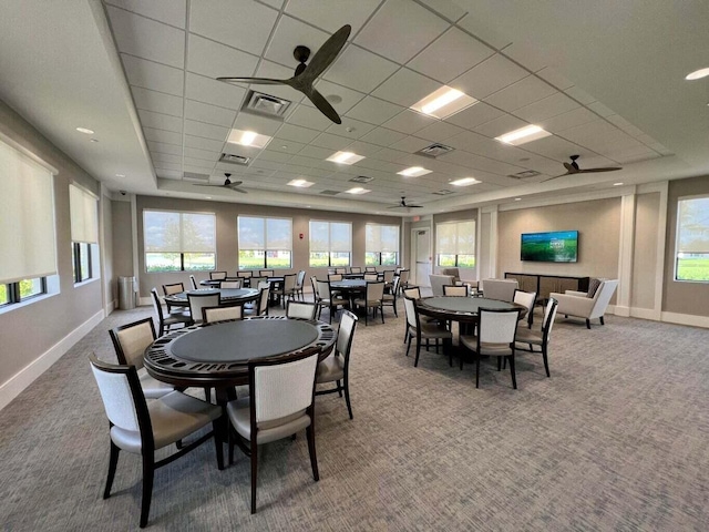 carpeted dining space featuring a paneled ceiling and ceiling fan