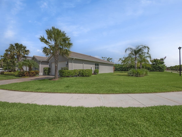 ranch-style home with a front lawn and a garage