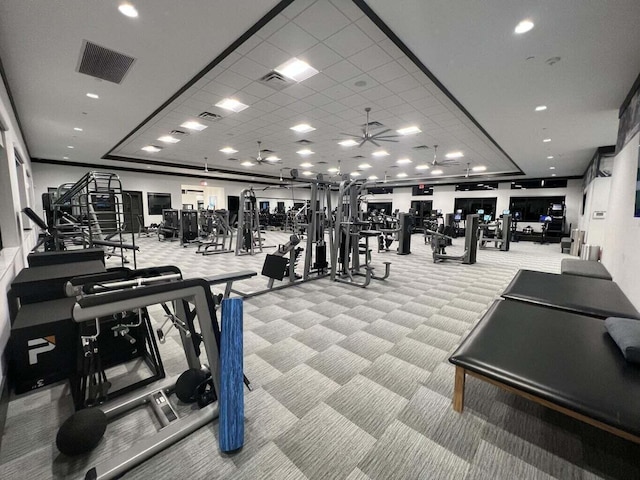 workout area with ceiling fan and light carpet