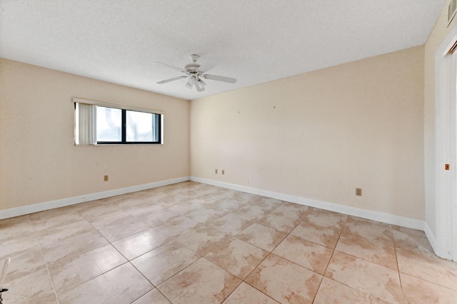 spare room with ceiling fan and light tile patterned flooring