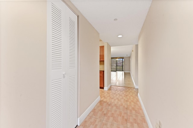 hall with light tile patterned floors