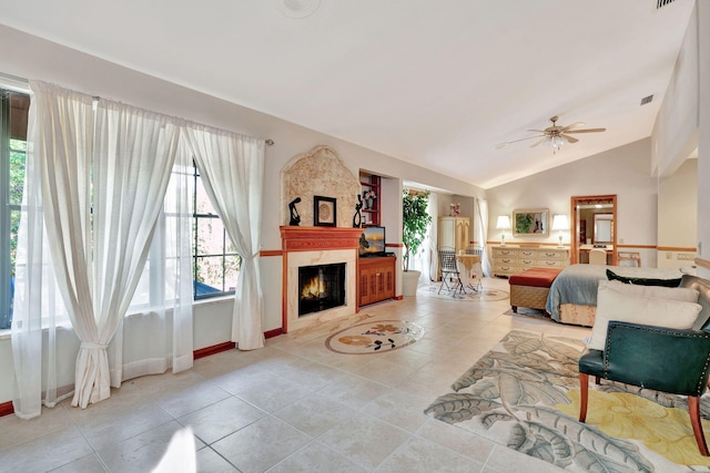 bedroom featuring ceiling fan, light tile patterned floors, and lofted ceiling