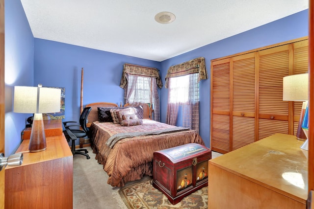 bedroom with light carpet and a closet