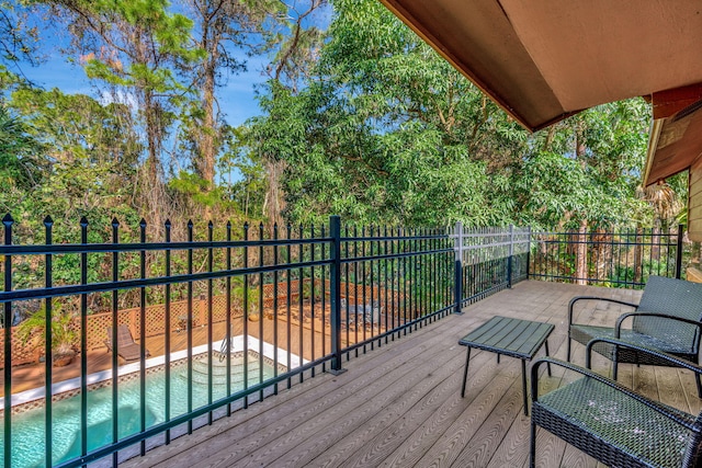 wooden deck with a fenced in pool