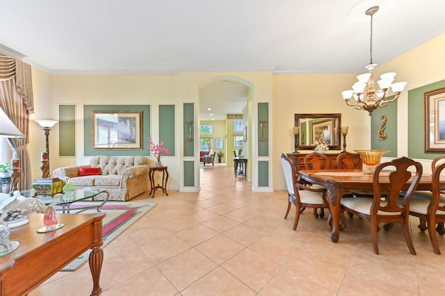 dining room with a chandelier, light tile patterned floors, and crown molding