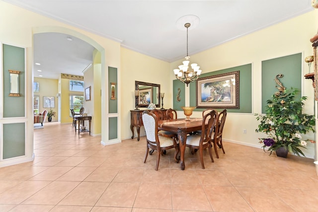 tiled dining area with a chandelier and ornamental molding