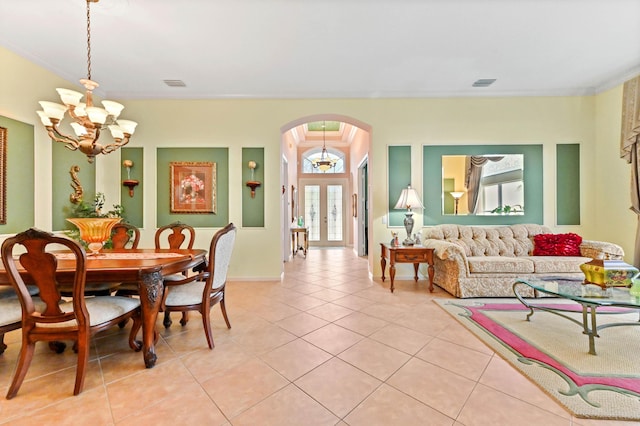 dining room with a chandelier, light tile patterned floors, and ornamental molding