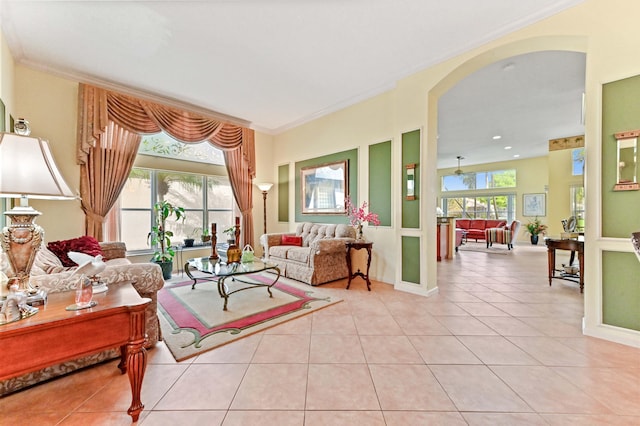 tiled living room featuring a wealth of natural light and ornamental molding