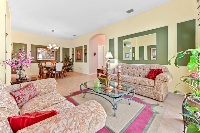 tiled living room featuring an inviting chandelier