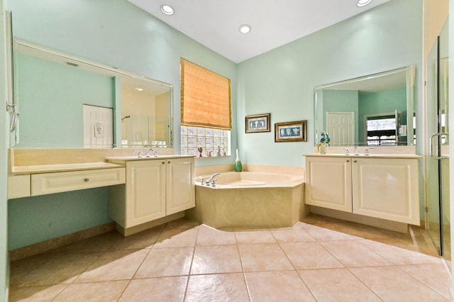 bathroom featuring plus walk in shower, tile patterned flooring, and vanity