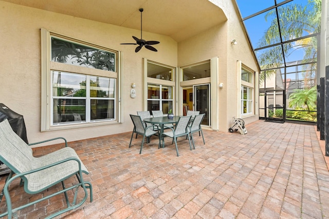 view of patio / terrace featuring glass enclosure and ceiling fan