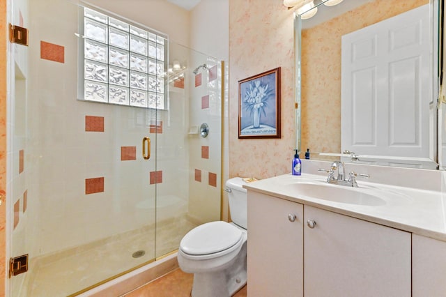 bathroom with an enclosed shower, vanity, toilet, and tile patterned floors