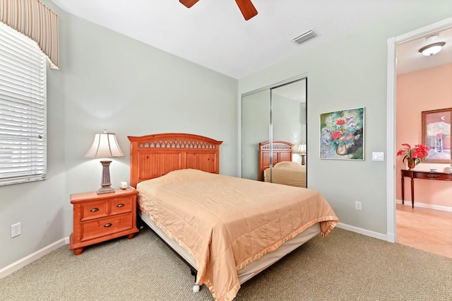 carpeted bedroom with a closet and ceiling fan