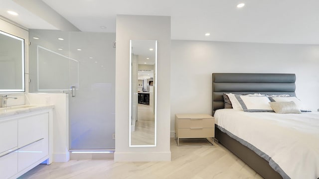 bedroom featuring sink and light wood-type flooring