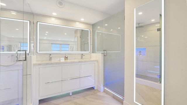 bathroom featuring vanity and a shower with shower door