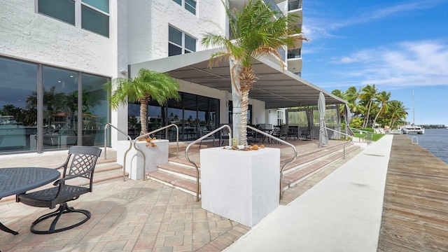 view of community featuring a patio area and a water view