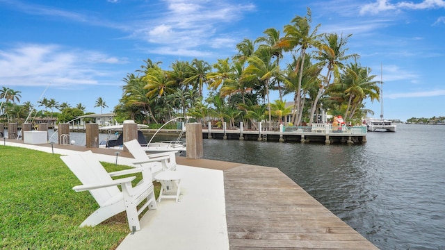 dock area with a water view and a yard