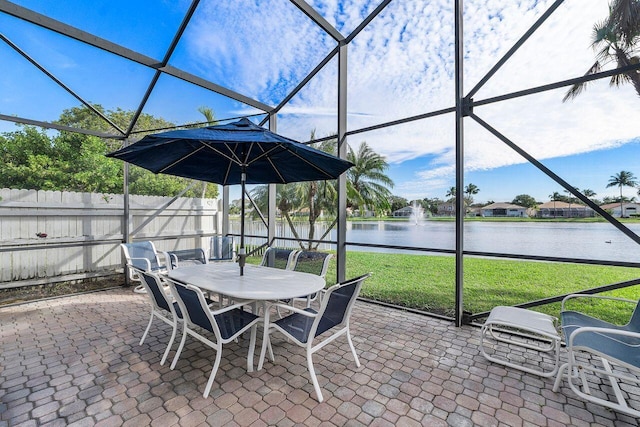 view of patio with a water view and glass enclosure