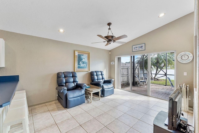 sitting room featuring ceiling fan, lofted ceiling, and light tile patterned flooring