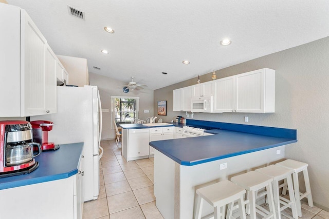 kitchen with white cabinets, ceiling fan, white appliances, and kitchen peninsula