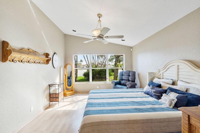 bedroom with light wood-type flooring, ceiling fan, and lofted ceiling