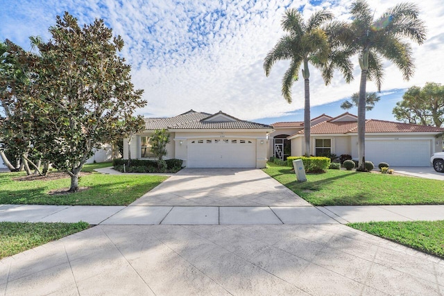 view of front of home featuring a garage and a front lawn