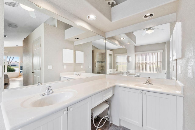 bathroom featuring an enclosed shower, vanity, and ceiling fan