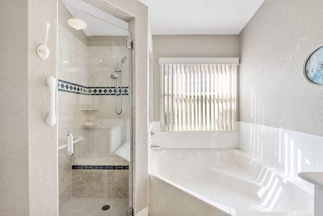 bathroom featuring separate shower and tub