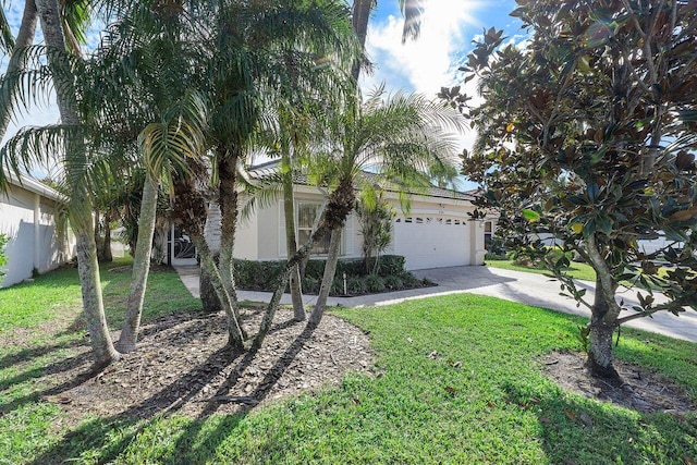 view of front facade with a garage and a front lawn