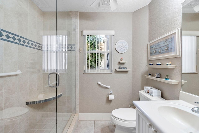 bathroom with toilet, vanity, tile patterned floors, and an enclosed shower