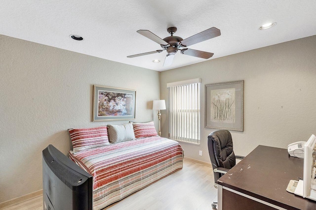 bedroom with light hardwood / wood-style flooring and ceiling fan